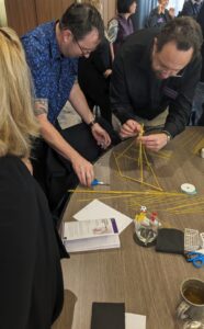 Participants immersed in a fun team activity during a workshop on innovation, leadership & wellbeing for a team of 50